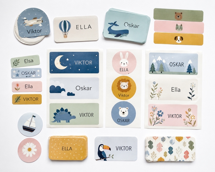 Namnlappar med motiv som valar, månar och djur och namnen Viktor, Ella och Oskar